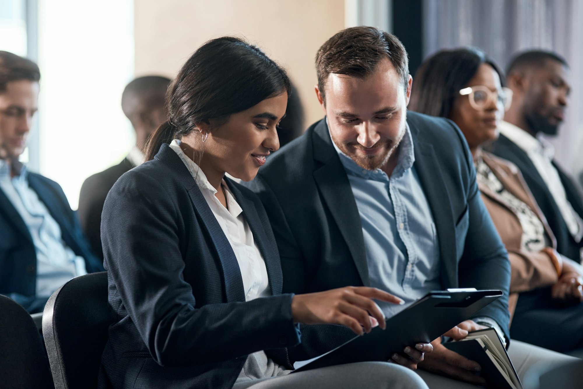 Shot of a group of businesspeople using a digital tablets during a conference